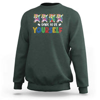 Dark forest green crewneck sweatshirt with colorful unicorn graphic and “Dare to be yourself” text