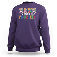 Purple crewneck sweatshirt with colorful unicorn graphic and “Dare to be yourself” text