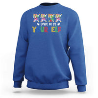 Royal blue crewneck sweatshirt with colorful unicorn graphic and “Dare to be yourself” text