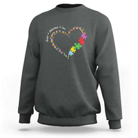 Charcoal gray sweatshirt with heart puzzle-piece graphic and autism awareness text