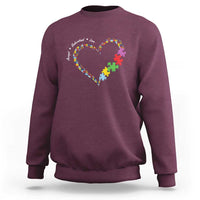 Maroon sweatshirt with heart puzzle-piece graphic and autism awareness text