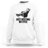 White crewneck sweatshirt with “JUST RESTING MY EYES” graphic and cat on a chair