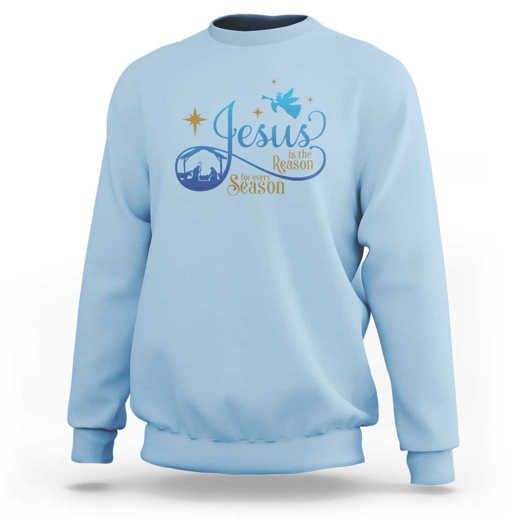 Light blue sweatshirt with blue nativity “Jesus … the Season” graphic on the chest