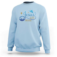 Light blue sweatshirt with blue nativity “Jesus … the Season” graphic on the chest