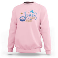 Light pink sweatshirt with blue nativity “Jesus … the Season” graphic on the chest