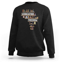 Black crewneck sweatshirt with 'Education Is Freedom' books graphic at center front