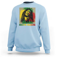 Light blue sweatshirt with reggae portrait graphic and “ROOTS REGGAE” text on front.