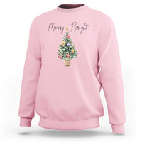 Light pink crewneck sweatshirt with Merry Bright text and Christmas tree graphic