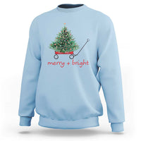 Light blue Christmas sweatshirt with wagoned Christmas tree graphic and “merry + bright” text