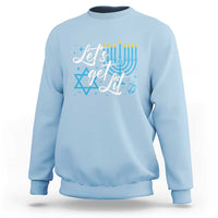 Men's light blue Hanukkah sweatshirt with “Let’s get lit” menorah and Star of David graphic