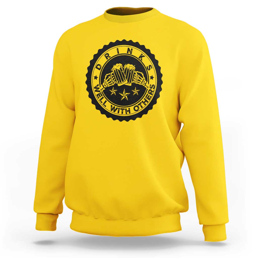 Daisy yellow crewneck sweatshirt with black circular drink graphic on the chest.