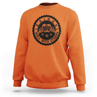 Orange crewneck sweatshirt with black circular drink graphic on the chest.