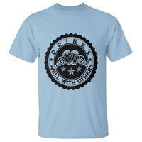 Light blue T-shirt with black round graphic print on the chest