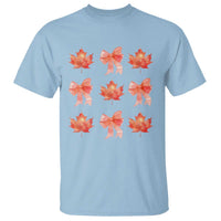Light blue T-shirt with orange maple leaf and bow graphic print