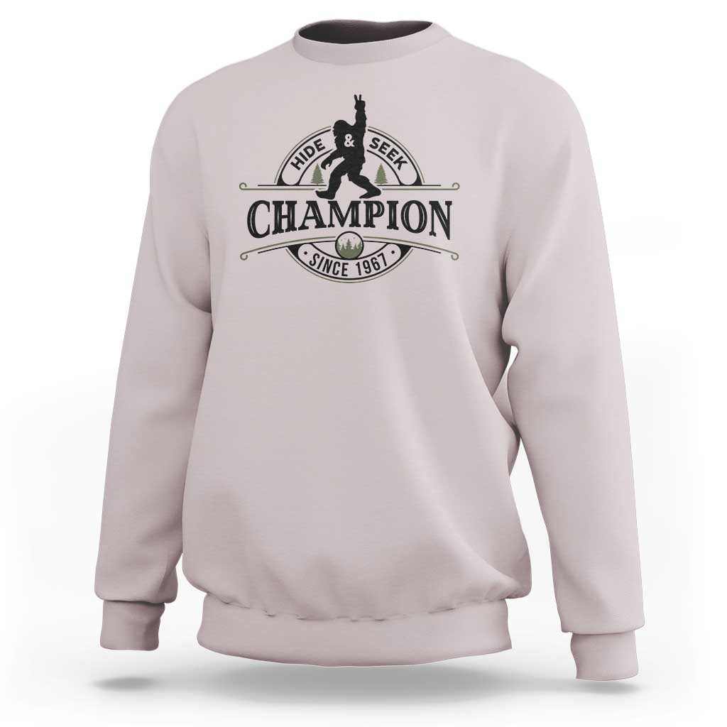 Light gray crewneck sweatshirt with Hide & Seek Champion Sasquatch graphic