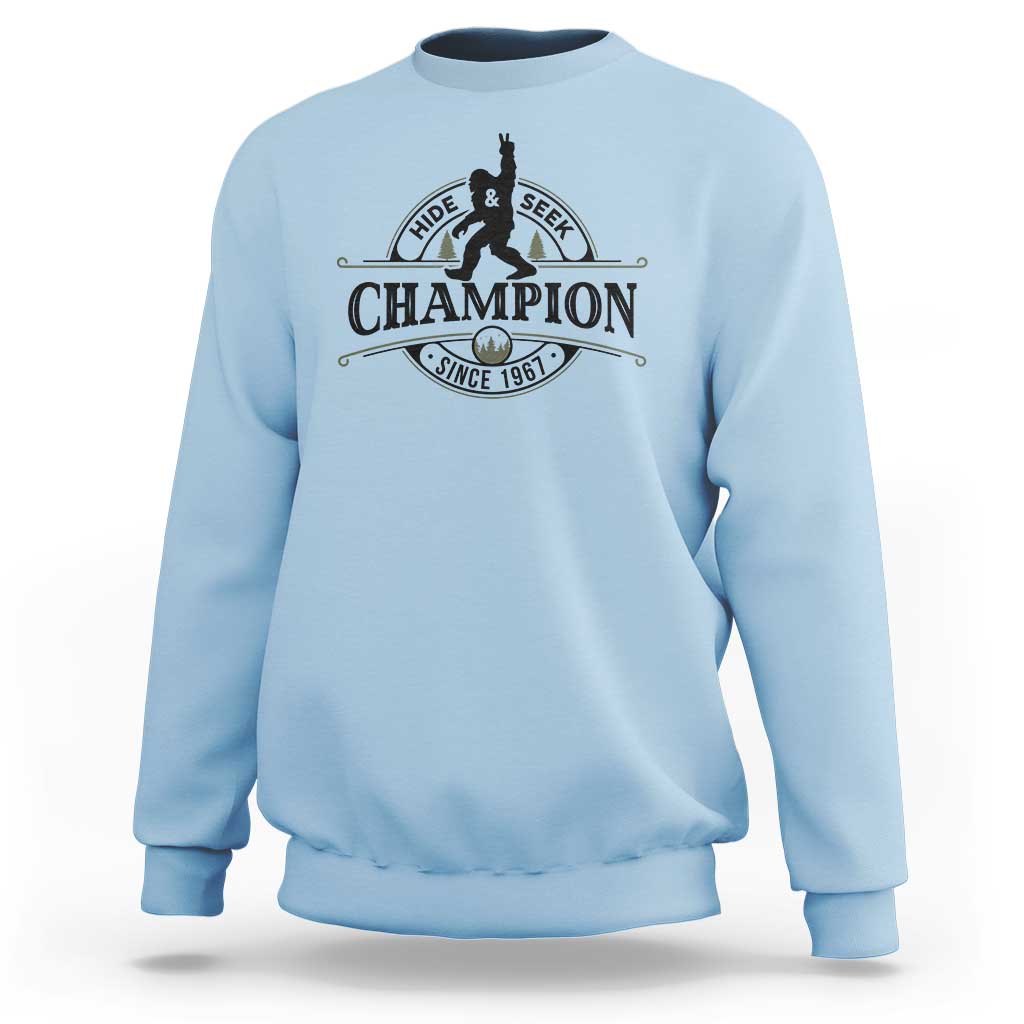 Light blue crewneck sweatshirt with Hide & Seek Champion Sasquatch graphic
