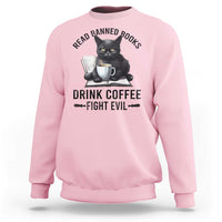 Light pink sweatshirt with reading cat graphic and 'Drink Coffee Fight Evil' print