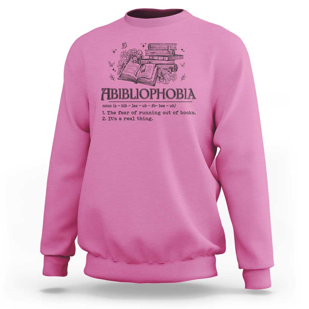 Pink crewneck sweatshirt with book-and-butterfly graphic and bold text design