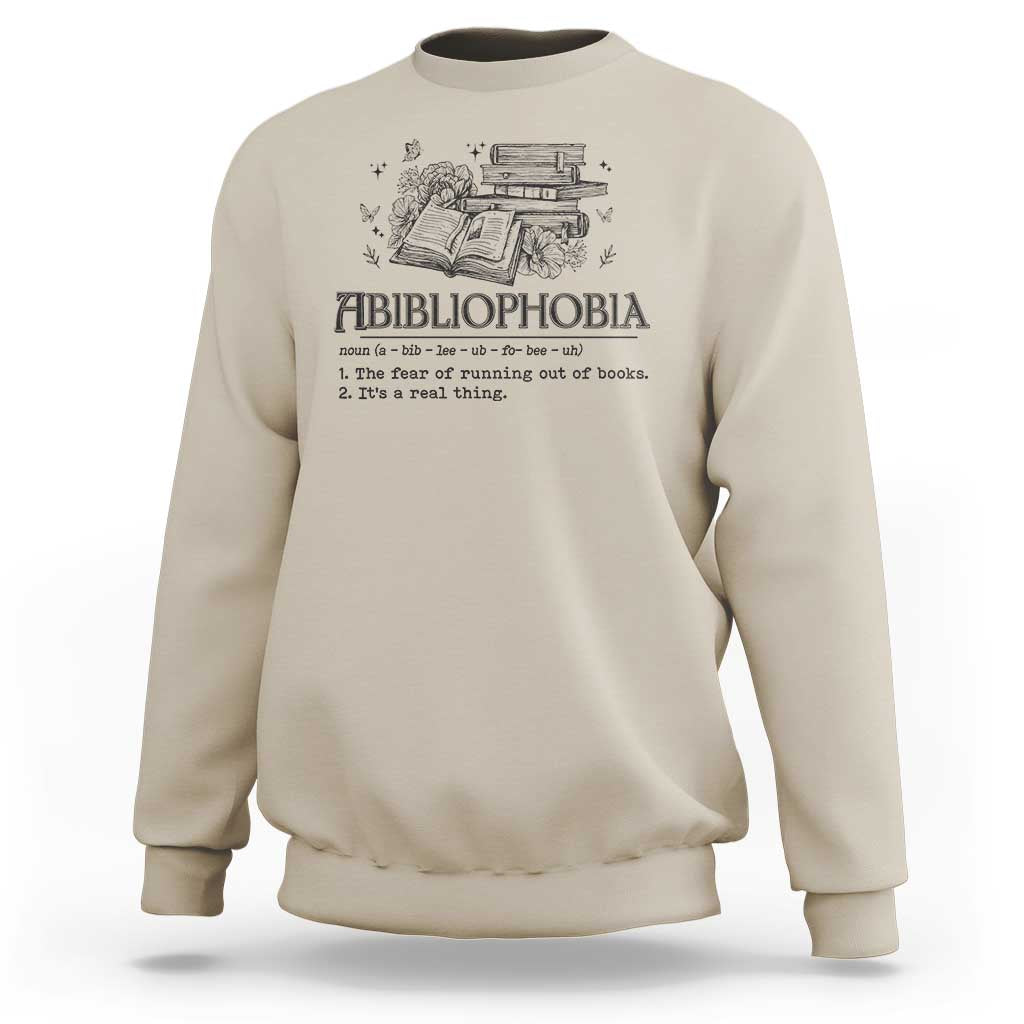 Beige crewneck sweatshirt with book-and-butterfly graphic and bold text design