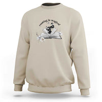 Sand beige sweatshirt with open book and flower graphic plus 'Reading is magical' text