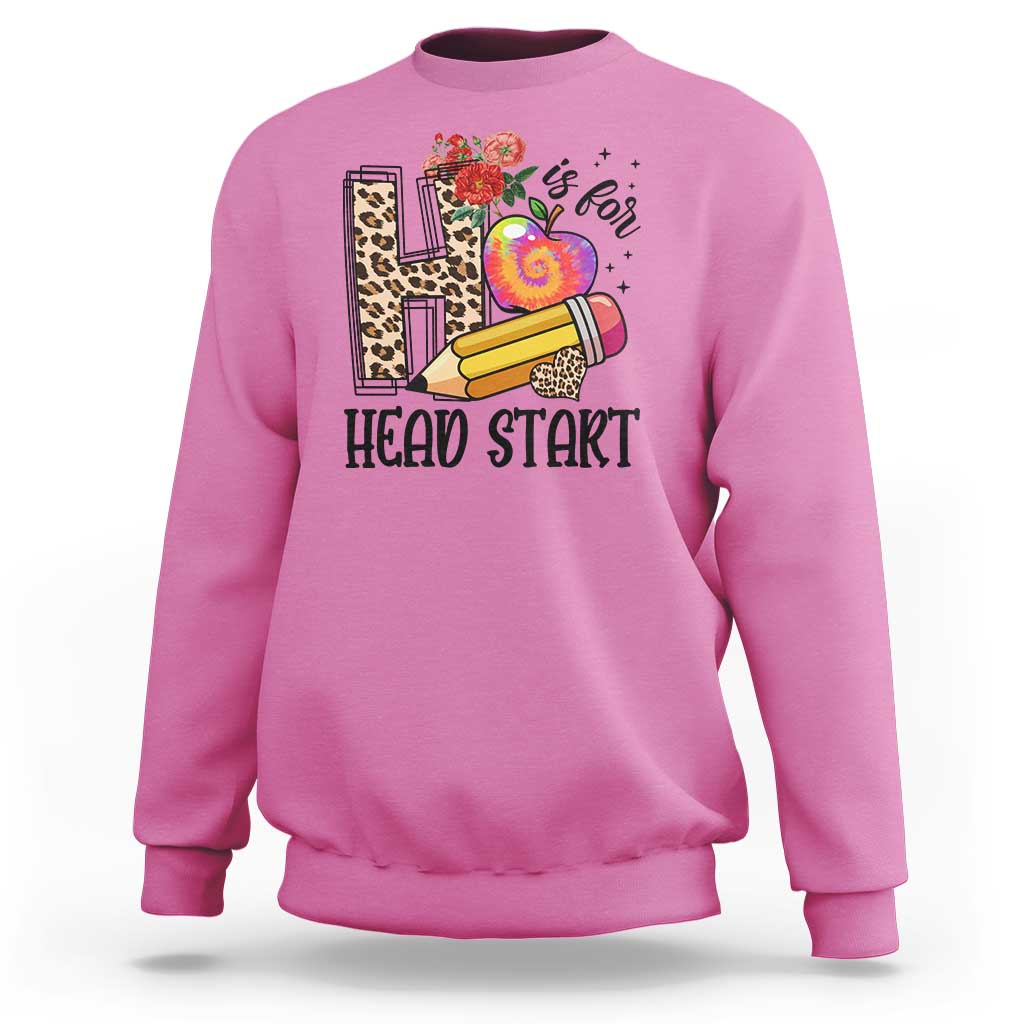 Azalea pink kids crewneck sweatshirt with “Head Start” pencil, apple, and flower graphic.