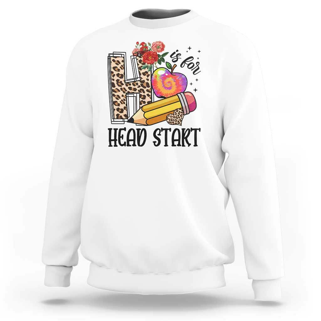 White kids crewneck sweatshirt with “Head Start” pencil, apple, and flower graphic.