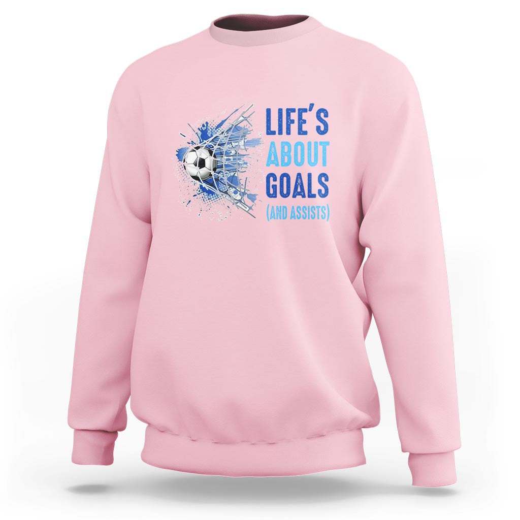 Light pink soccer sweatshirt with blue “Life’s About Goals (and Assists)” graphic on chest