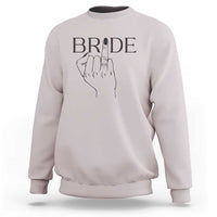 Ice gray bride sweatshirt with “BRIDE” print and hand ring graphic on chest