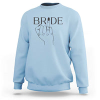 Light blue bride sweatshirt with “BRIDE” print and hand ring graphic on chest
