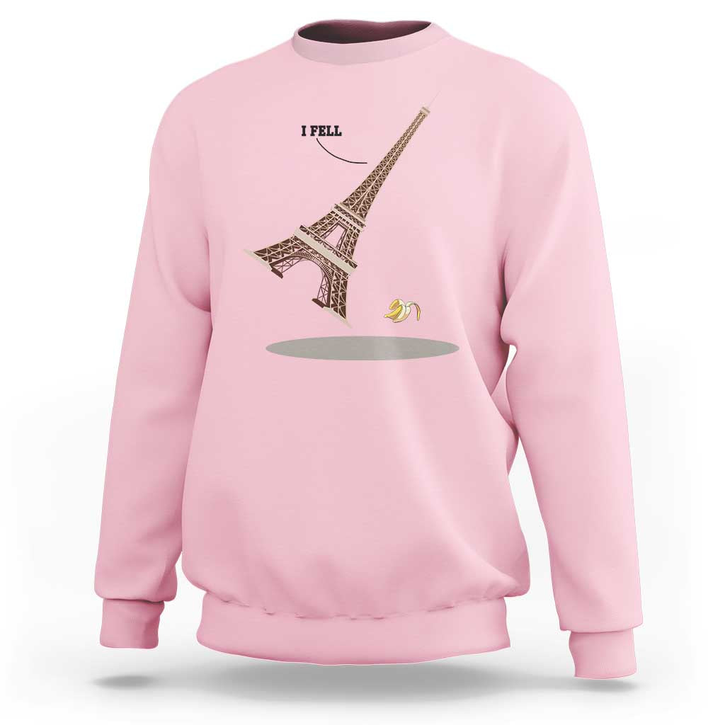 Light pink Eiffel Tower graphic sweatshirt with “I FELL” text and banana peel design