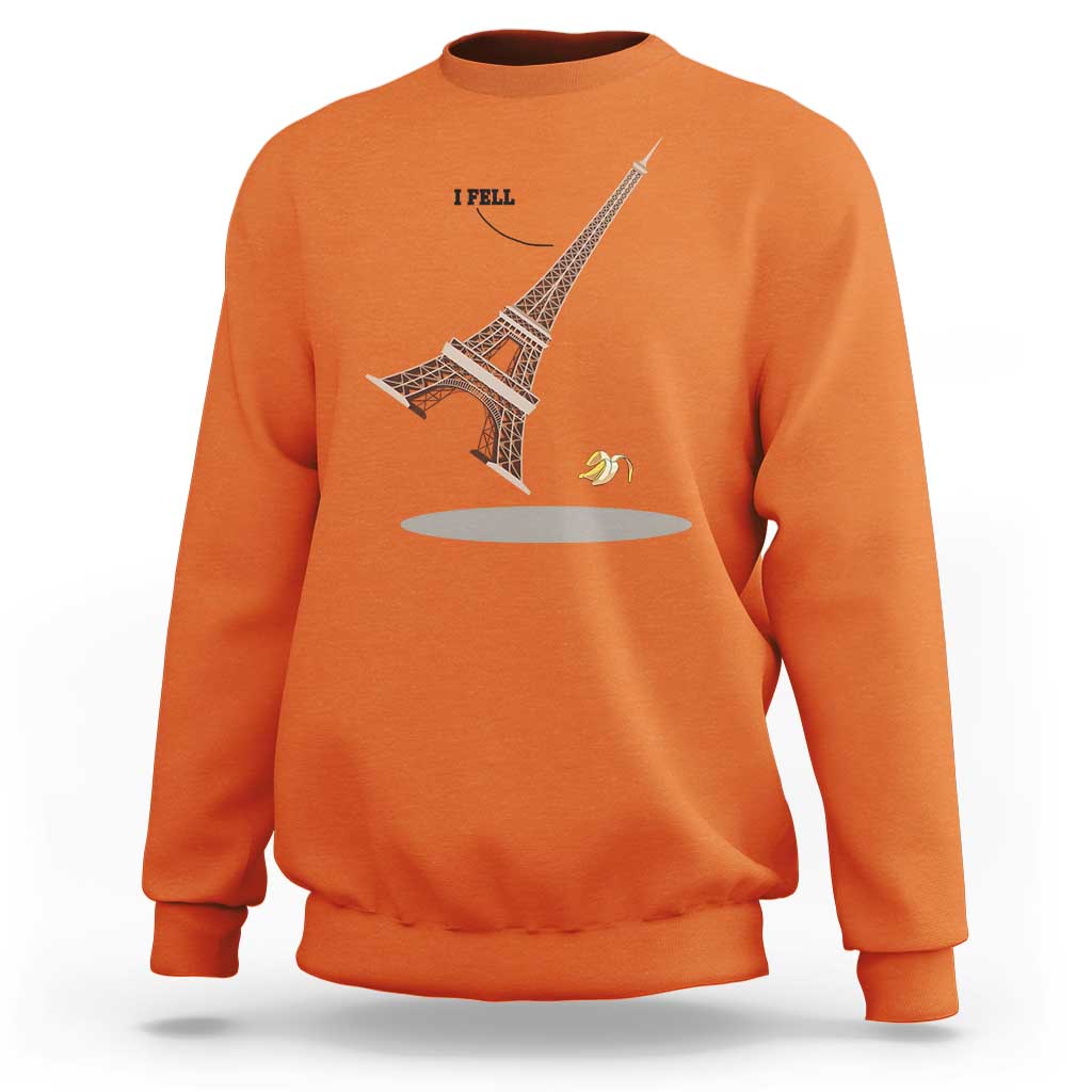 Orange Eiffel Tower graphic sweatshirt with “I FELL” text and banana peel design