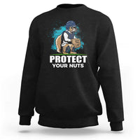 Black crewneck sweatshirt with baseball squirrel graphic and “PROTECT YOUR NUTS” print