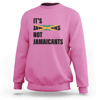 Pink sweatshirt with bold “It’s Jamaicans Not Jamaicants” text graphic on chest