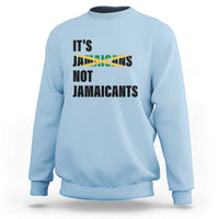 Light blue sweatshirt with bold “It’s Jamaicans Not Jamaicants” text graphic on chest