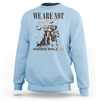 Light blue crewneck sweatshirt with 'WE ARE NOT' witch graphic, lantern, and 'HARRIS WALZ '24' text
