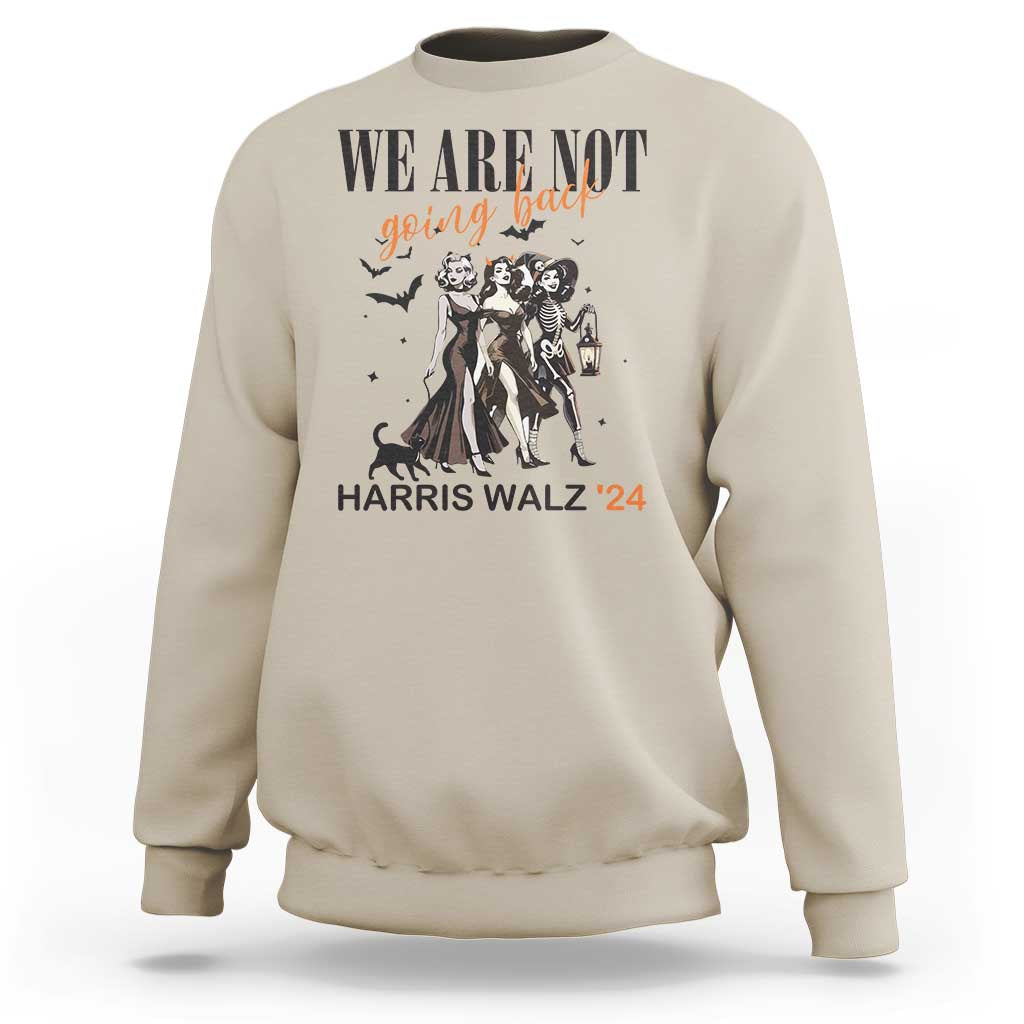 Sand crewneck sweatshirt with 'WE ARE NOT' witch graphic, lantern, and 'HARRIS WALZ '24' text