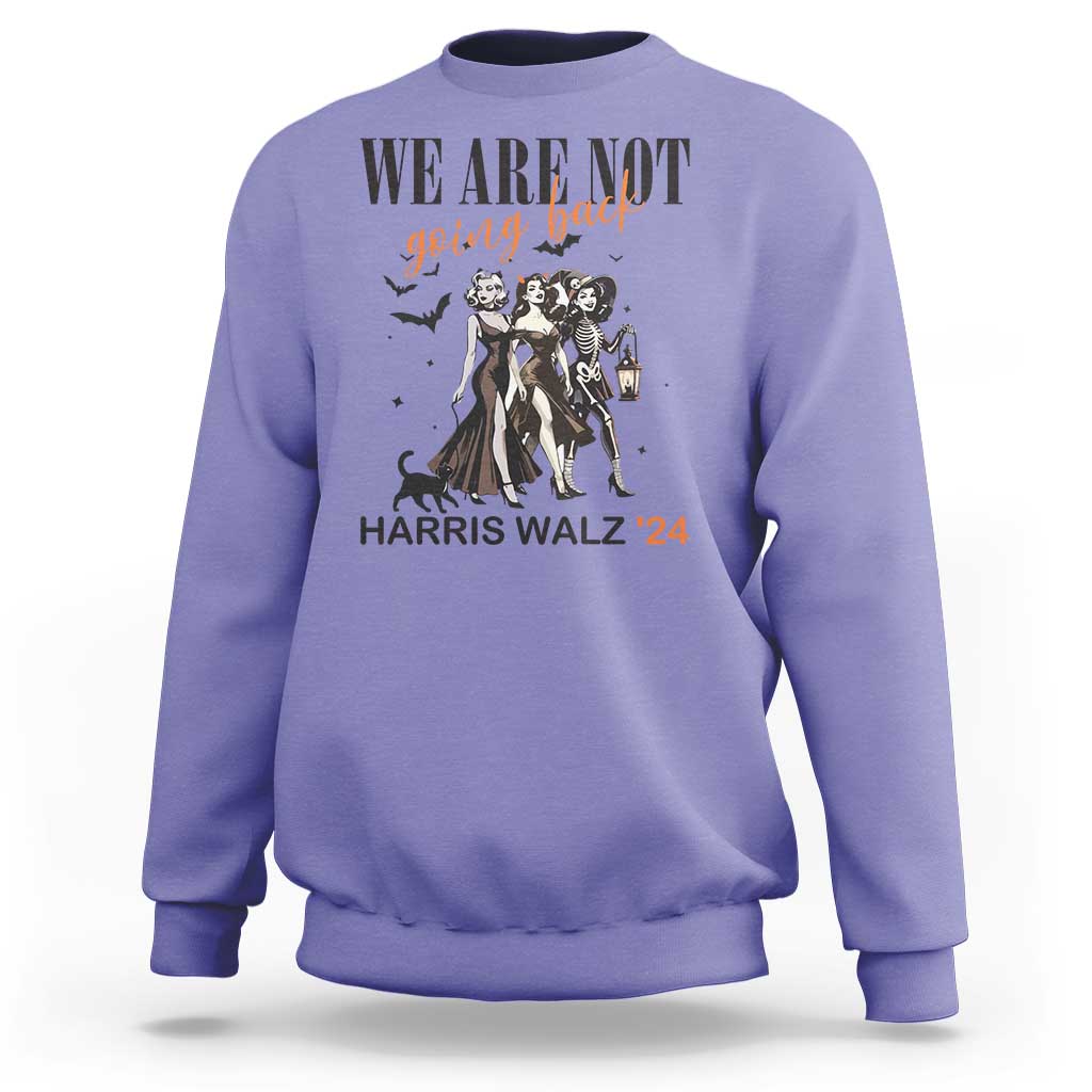 Violet crewneck sweatshirt with 'WE ARE NOT' witch graphic, lantern, and 'HARRIS WALZ '24' text