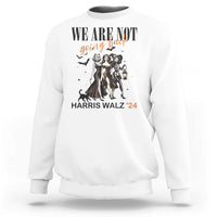 White crewneck sweatshirt with 'WE ARE NOT' witch graphic, lantern, and 'HARRIS WALZ '24' text