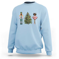 Light blue crewneck Christmas sweatshirt with nutcracker, tree, and ballerina graphic on chest
