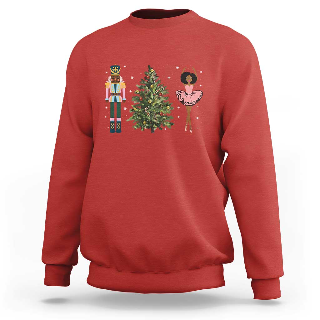Red crewneck Christmas sweatshirt with nutcracker, tree, and ballerina graphic on chest