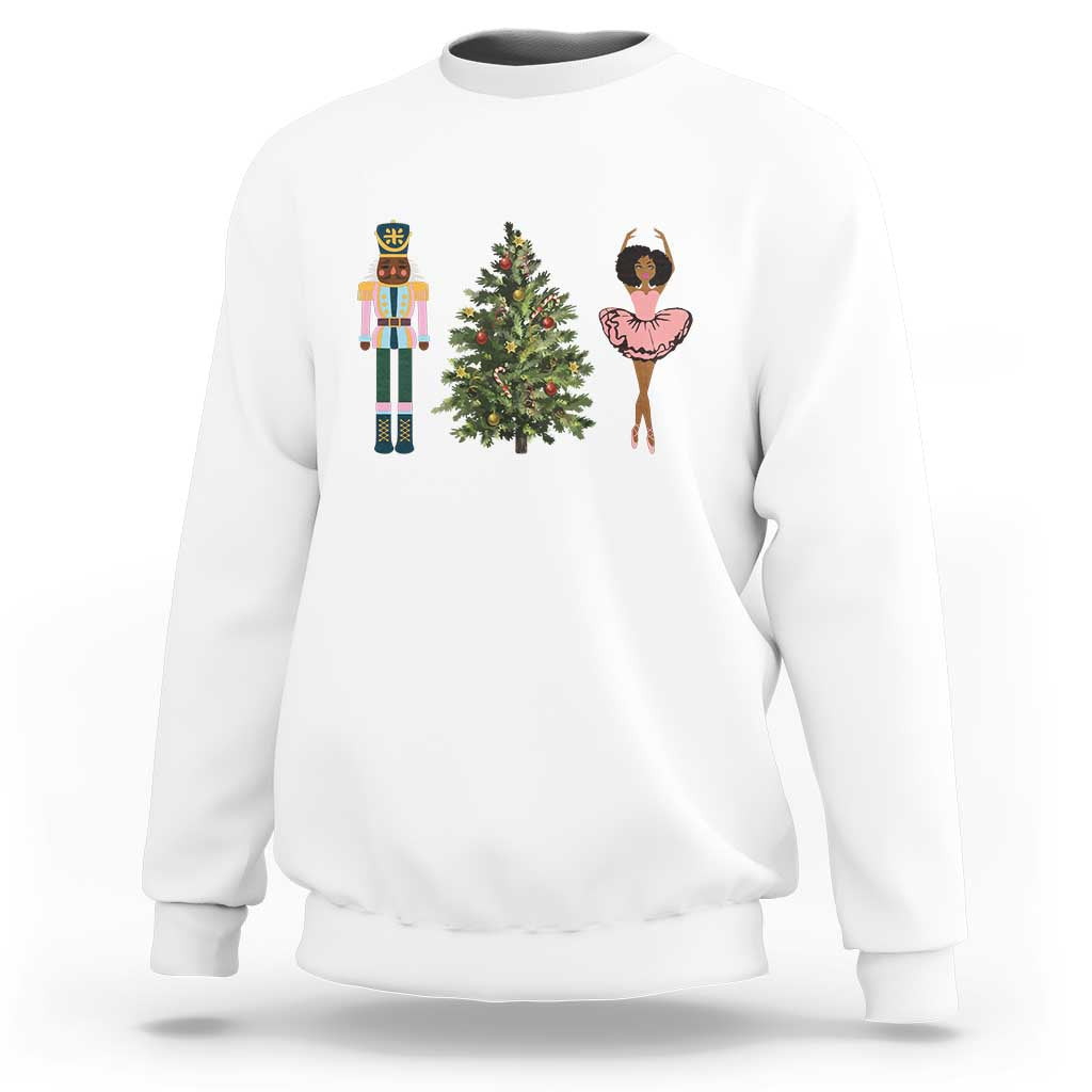 White crewneck Christmas sweatshirt with nutcracker, tree, and ballerina graphic on chest