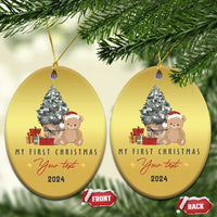Gold oval Christmas ornament with teddy and tree, “My First Christmas” and 2024