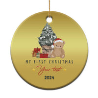 Gold round Christmas ornament with teddy and tree, “My First Christmas” and 2024