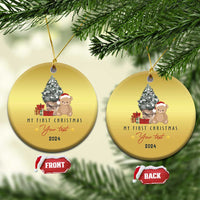 Gold round Christmas ornament with teddy and tree, “My First Christmas” and 2024