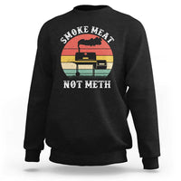 Black crewneck sweatshirt with “SMOKE MEAT NOT METH” grill graphic on the chest