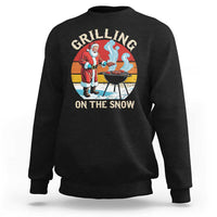 Black crewneck sweatshirt, back Santa grilling graphic: 'GRILLING ON THE SNOW'