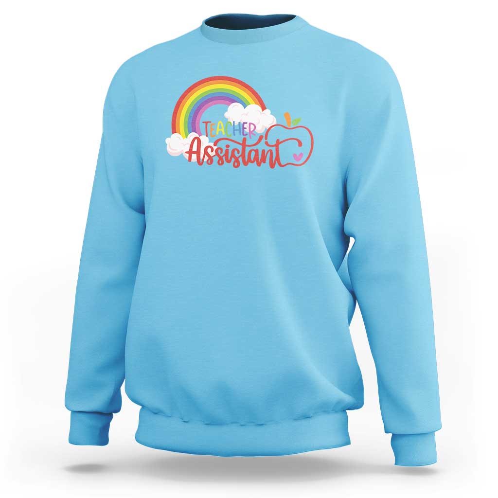 Sky blue teacher assistant sweatshirt with rainbow cloud apple graphic on front.