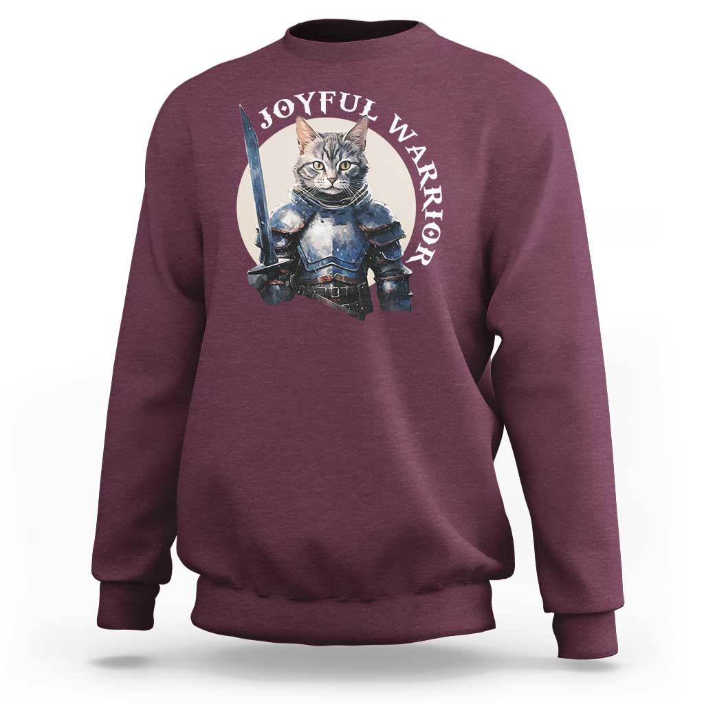 Maroon sweatshirt with kitten knight graphic and “JOYFUL WARRIOR” text on chest