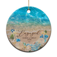 Personalized engagement Christmas ornament, round blue beach scene with “Engaged” and names/date.