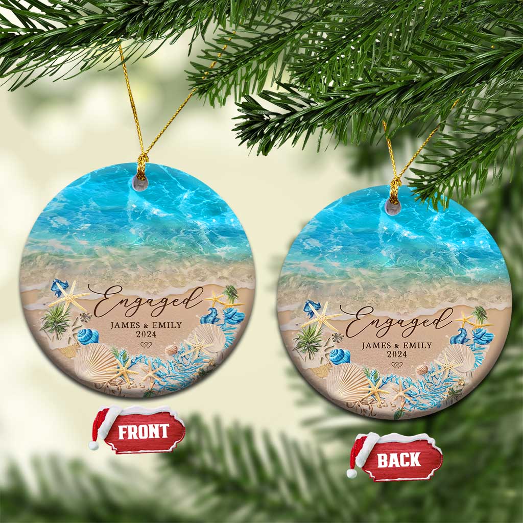 Personalized engagement Christmas ornament pair, two round beach designs with “Engaged” and “2024”.